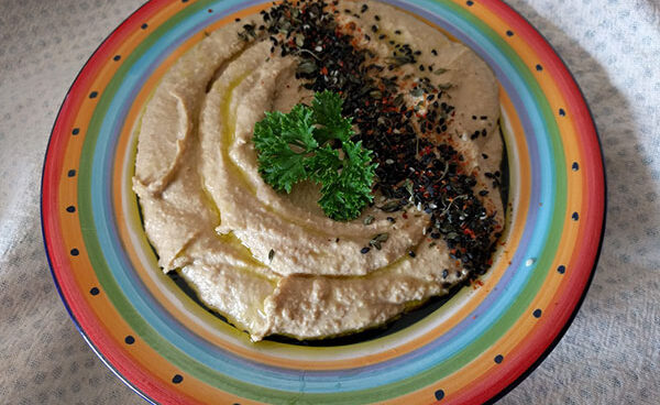 hummus di ceci servito su fatto in ceramica colorata